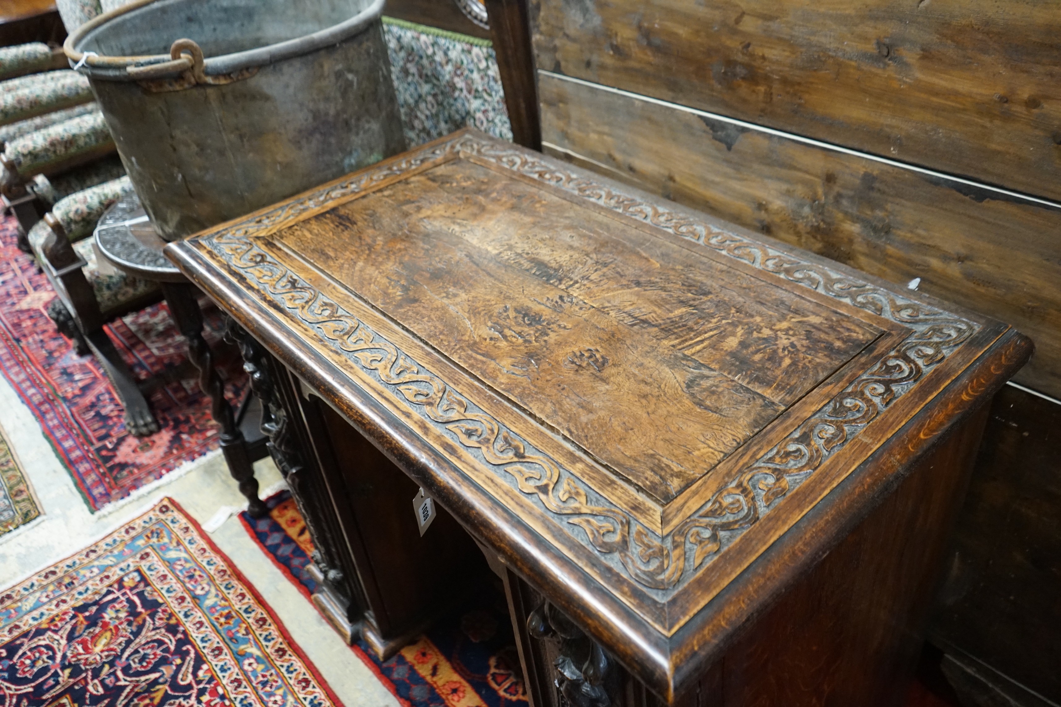 An 18th century carved oak kneehole desk, width 105cm, depth 59cm, height 81cm